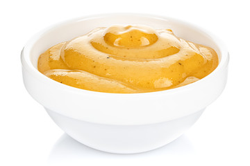 Mustard in a small white ceramic round bowl isolated on white background