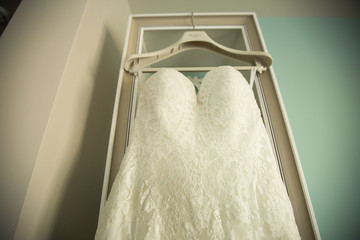 beautiful luxury wedding dress hanged on the door