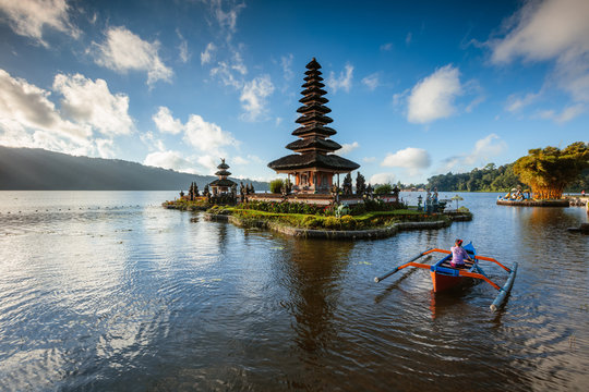 Balinese woman on boat near water temple, Bali