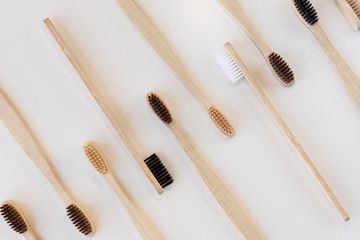 Group of eco bamboo toothbrushes, on white background. Different color. Top view, copy space....