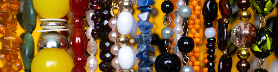 A lot of bracelets, beads and jewelry made of natural precious stones is in a pile: wedding...
