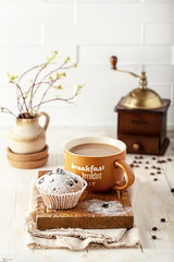 Obraz na płótnie Canvas breakfast with a cupcake and a cup of coffee