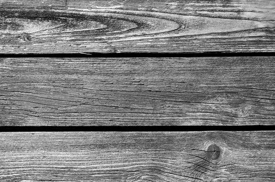 Old grungy wooden planks background in black and white.