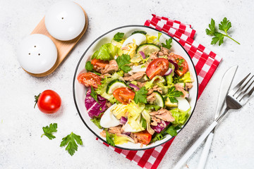 Tuna salad with green leaves, eggs and vegetables.