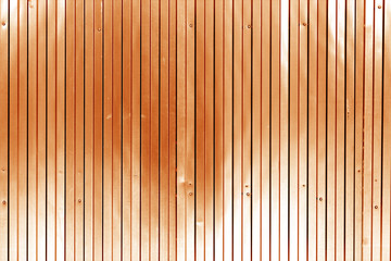 Metal list wall texture of fence in orange tone.