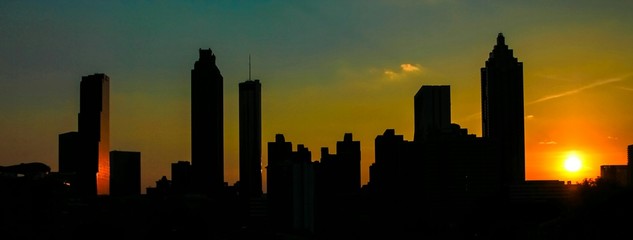 Fototapeta na wymiar Silhouette Cityscape Against Sky During Sunset