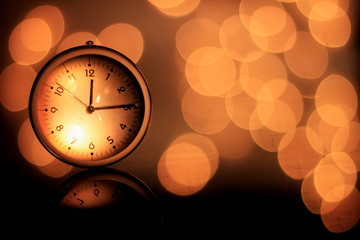 Clock showing twelve fifteen o'clock with golden shades