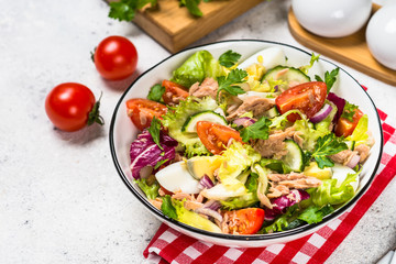 Tuna salad with green leaves, eggs and vegetables.