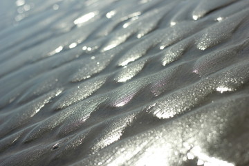 Macro photo of golden sand under rays of sunrise