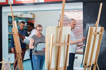 People in a painting class for beginners at the easel