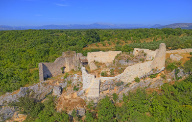 Fototapeta na wymiar Drone aerial view of the archaeological remains of the medieval fort Necven, located on the west side of mountain Promina on top of the canyon of the river Krka in Croatia in Promina County.