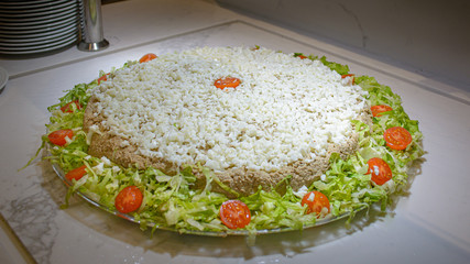 chicken liver pate, garnished with boiled eggs, lettuce and cherry tomatoes