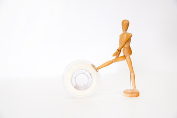 3D printing filament reels with wooden anthropomorphic doll on white background