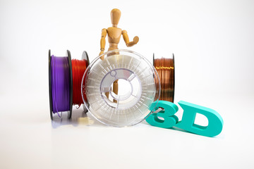 3D printing filament reels with wooden anthropomorphic doll with text 