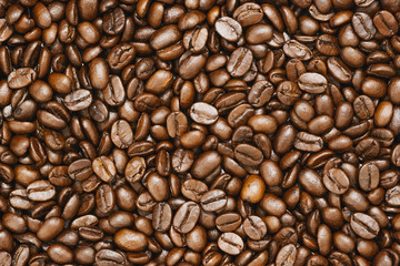 Top view of brown roasted coffee beans, can be use as background, copy space for text.