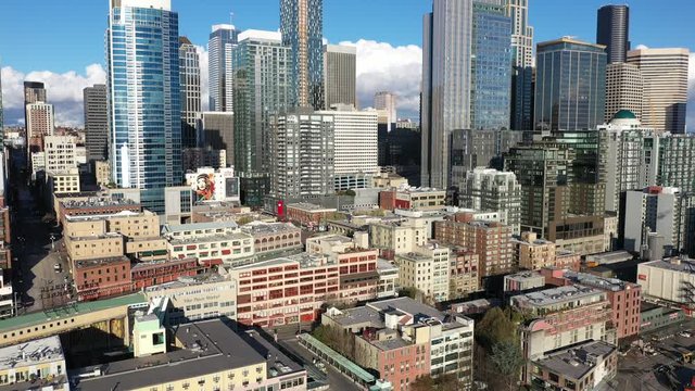 Drone footage of the Pike Place Market, Seattle downtown, high-rise buildings, empty streets, with nearby skyscrapers during the epidemic