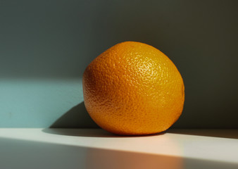 Juicy golden orange on a bright background