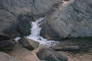 small stream of water flowing through the rocks