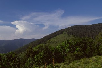 incredible mountain view with beautiful clouds in summer