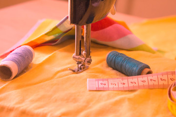 Sewing still life: colorful cloth. scissors and sewing kit includes threads of different colors, thimble and other sewing accessories