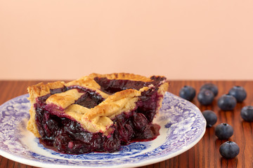 
Homemade blueberry pie on a white and blue plate.