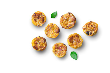 Mini savory pies with cheese, olives, herbs and bits of chorizo sausage - little appetizer tartlets isolated on white background