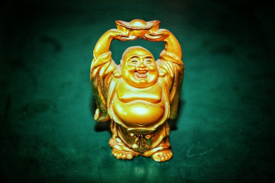 Laughing buddha golden statue with green background Stock Photo | Adobe  Stock