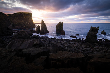 Scenic valahnukamoel volcanic rock formation at atlantic coast in Iceland during sunrise on a cloudy day - Powered by Adobe