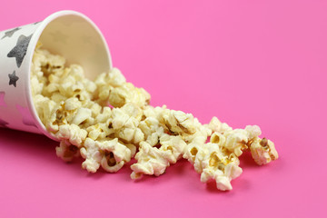 Inverted paper Cup with caramel popcorn background