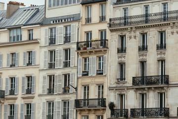 Typical old Paris architecture, facades of residential buildings with balconies and mansards, expensive real estate concept. City residents self isolation, deserted streets, european lifestyle