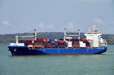 Geared container ship transiting through Panama Canal on her international trade route. 