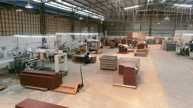 People work in a woodworking factory. Workflow in a furniture factory. Work in a furniture factory