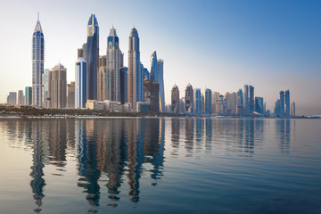 Obraz premium Modern and Luxury Dubai Marina with reflection - famous Jumeirah beach at sunrise, United Arab Emirates