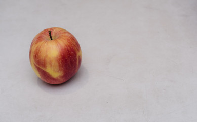 One red Apple on a white background, an Apple on a white table, fresh yellow apples in the kitchen