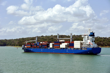 Geared container ship transiting through Panama Canal on her international trade route. 