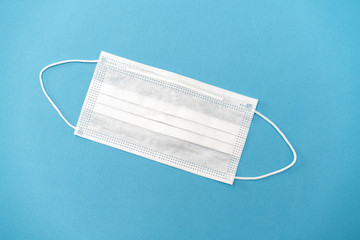 Surgical white mask for protection on a blue background