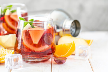 Sangria and ingredients in glasses on wood background, copy space