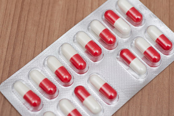 blister pack of pills, red and white capsules