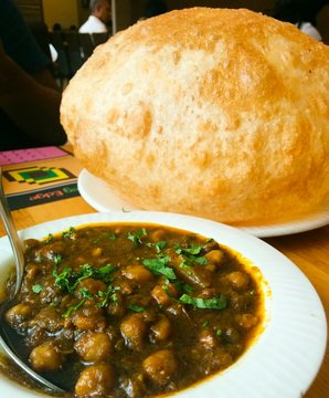 Close-up Of Chole Bhature Served On Table At Restaurant