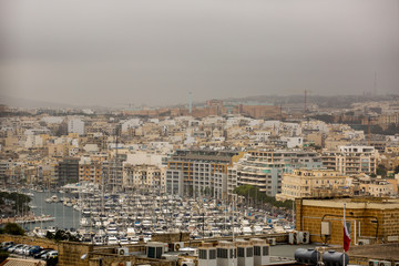 Fototapeta premium beautiful view of old city and the harbour with colorful boats in Malta