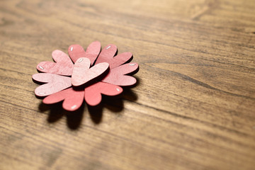 Red hearts on a wooden surface background with text space. The concept of love and feelings