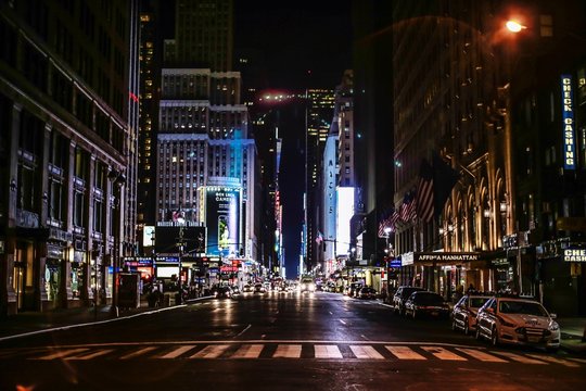 Street Amidst Illuminated Buildings At Night