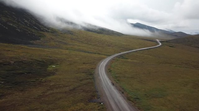 Storm rolling in with two hitchhikers waiting by the Dempster Highway