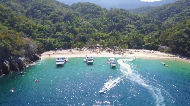 Aerial bird's eye view of Coastline with boats docked in tropical private beach - sapphire waters, Playa Mita, Riviera Nayarit, Mexico