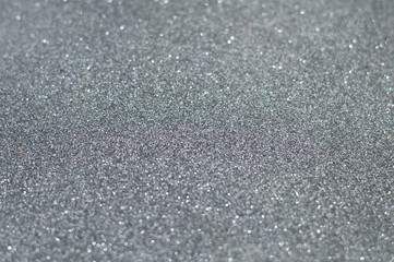 Silver glitter texture abstract background. Shiny glowing colors. Concept of high-tech, elegance, glamour or industry.