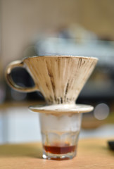 Brewed coffee in a special cup with a filter, closeup