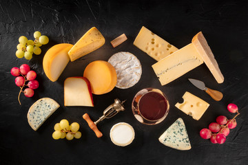 Cheese and wine, shot from the top on a black background