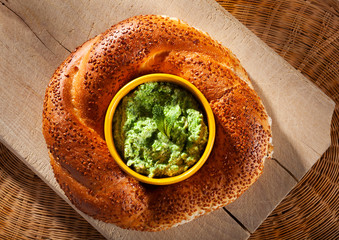 Turkish bagel or simit and broad beans spread with a mint leaf seen from above