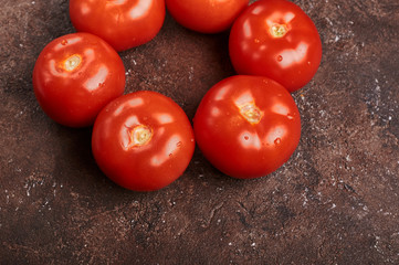 fresh tomatoes  on a brown background isolated