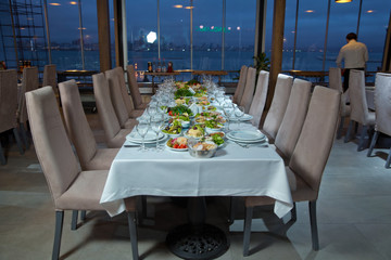 Salads and gums . Set of a dish with spoon, fork and knife on white table.Table setting on white table .